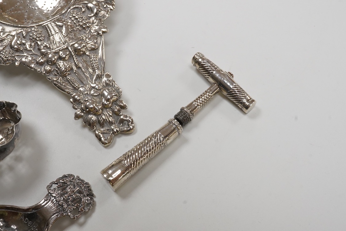 Small silver and white metal, including an Edwardian silver tea strainer, import marks for London, 1908, 15.7cm, a late Victorian silver sifter spoon, silver handled scissors with case, a white metal corkscrew and a whit